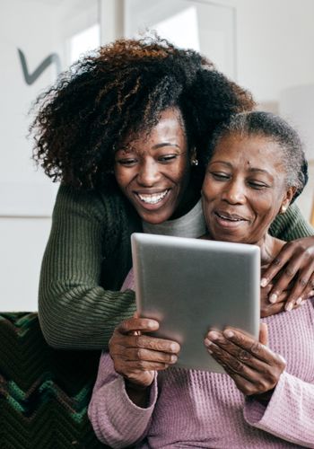 caregiver-helping-elderly-with-tech