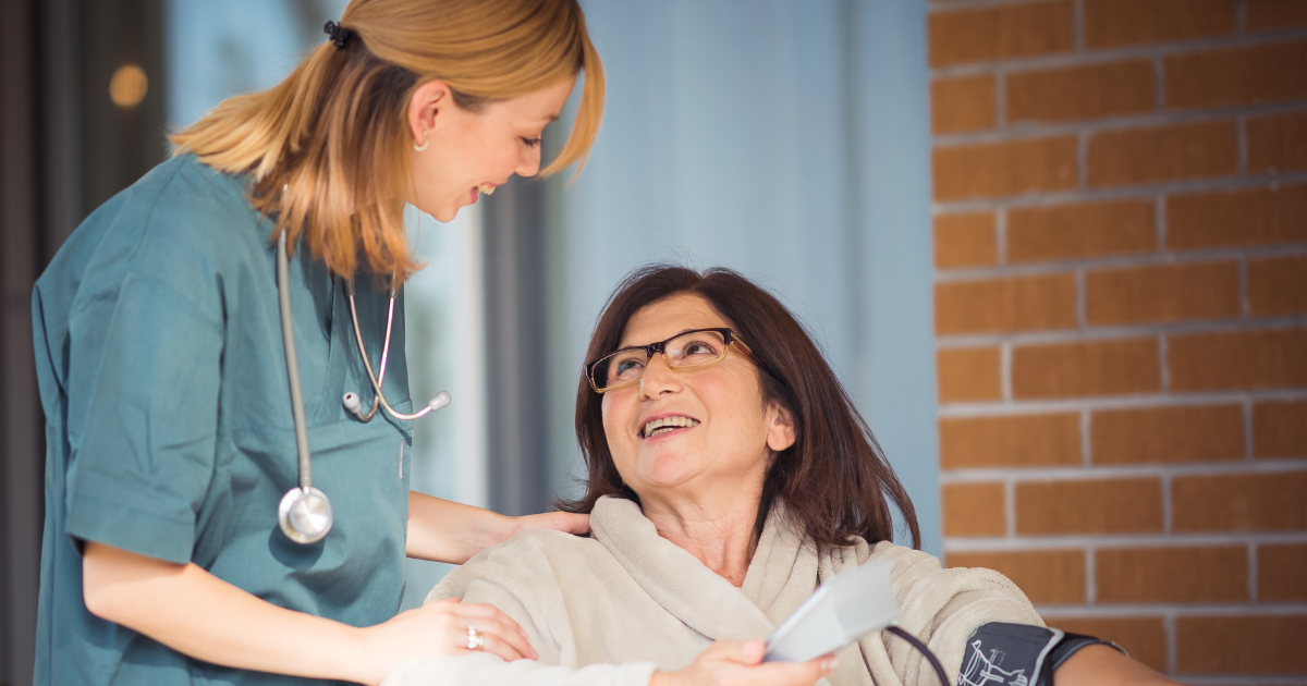 A professional provides home health care services to a woman.