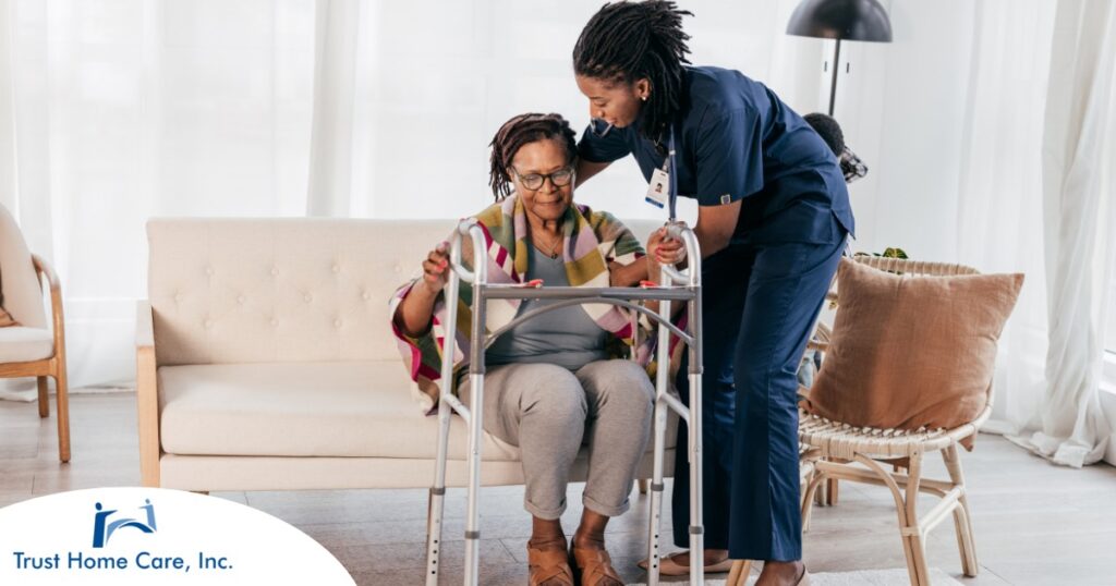 A care professional helps an older woman get up with the use of a walker, representing how occupational therapy can help with recovery.