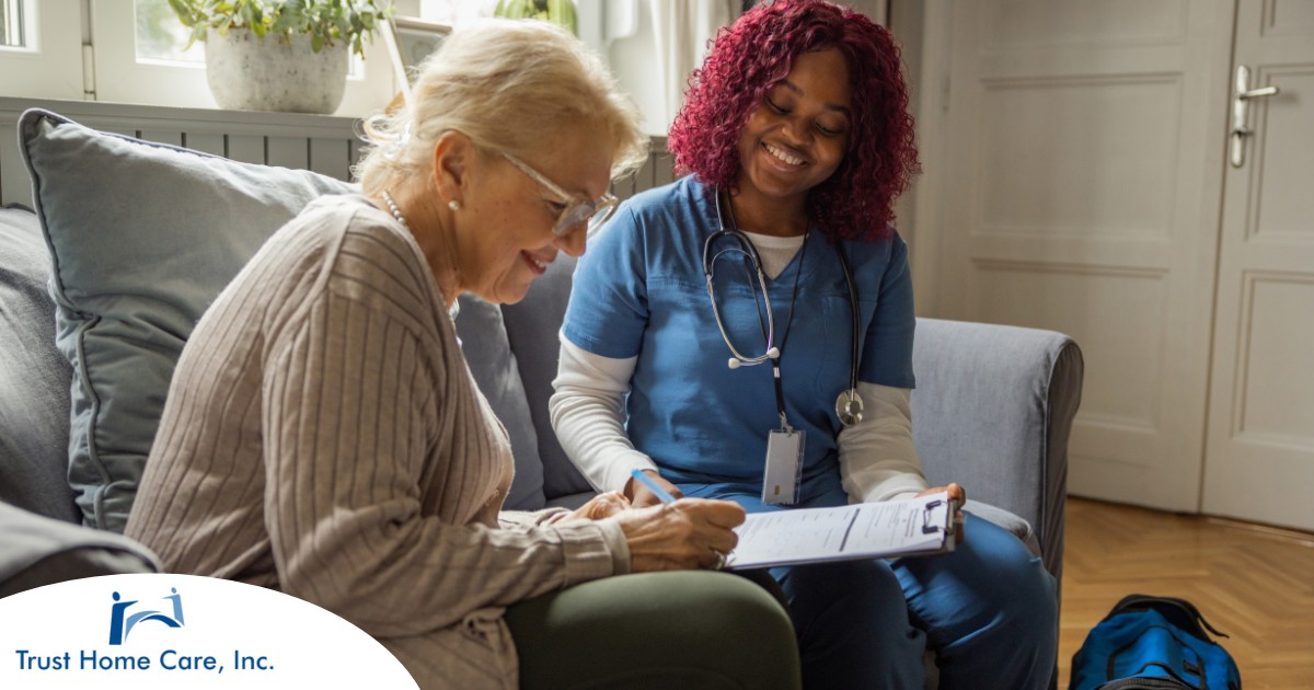 A healthcare professional helps an older patient fill out a form, representing what happens when the requirements for home health care eligibility are met.