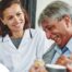 A woman smiles while with clients showing how you can enjoy senior caregiver jobs.
