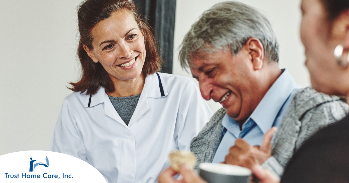 A woman smiles while with clients showing how you can enjoy senior caregiver jobs.