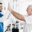 A healthcare worker and patient smile and high five representing the satisfaction that can come from a career as a physical therapy assistant.