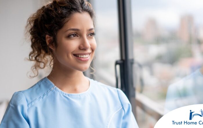 A woman smiles while looking ahead hopefully, showing the positive outlook that planning for a home care career can bring.