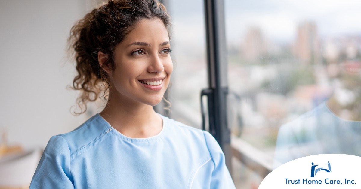 A woman smiles while looking ahead hopefully, showing the positive outlook that planning for a home care career can bring.
