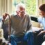 A woman has a good time with her older clients, representing the kind of personal skills needed to be a good caregiver.