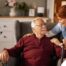 A caregiver helping a woman with a walker make her senior home safer.